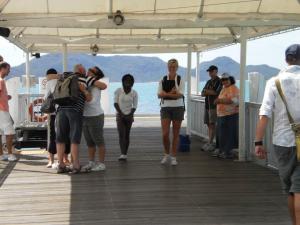 TEARS AT GATES:  Gracious Organizers bidding farewell to guests at the ferry port, a common custom in the island